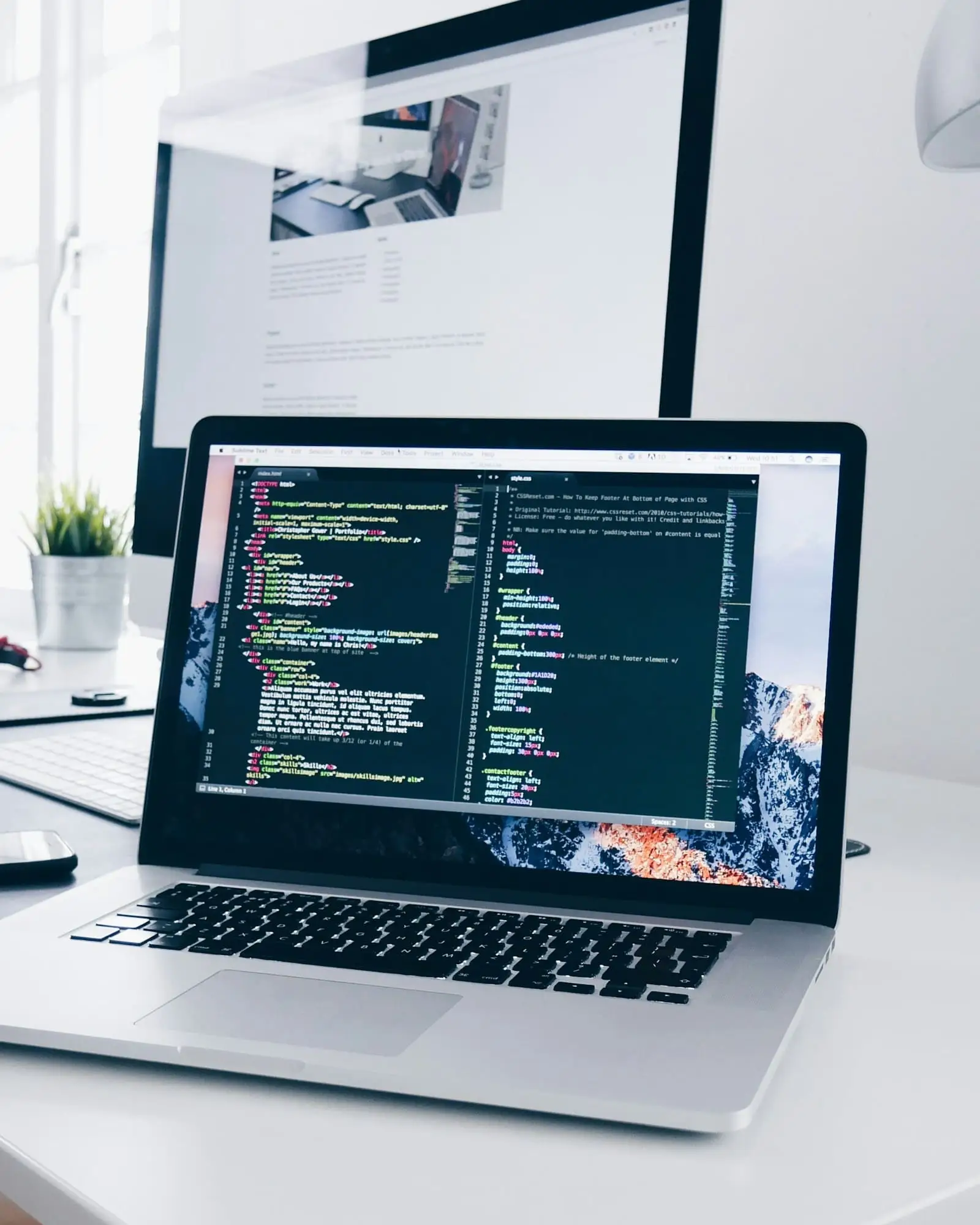 A laptop on a desk with a code editor open, representing hands-on product engineering and delivery.