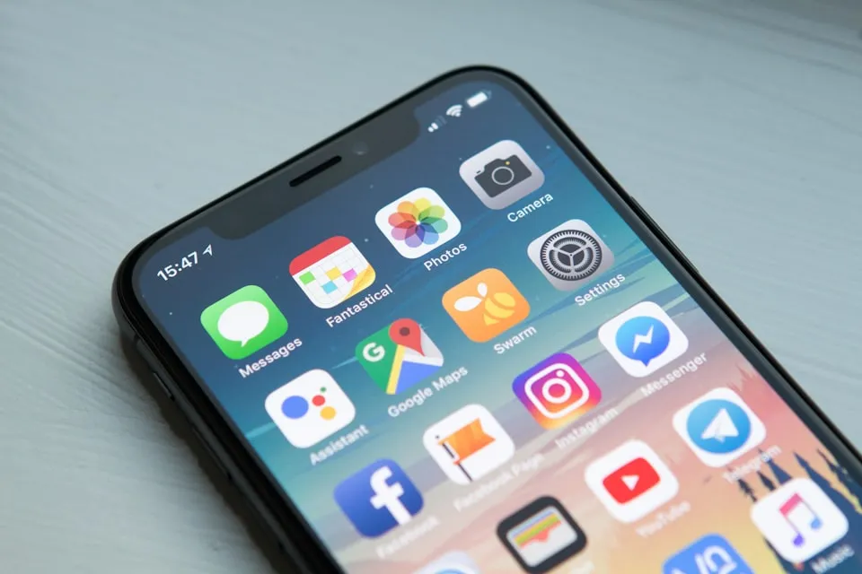 Person holding a smartphone showing a mobile application on the screen.